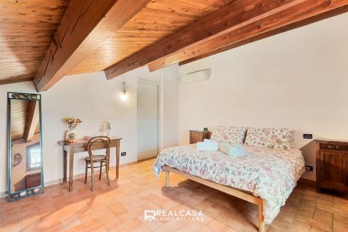 a bedroom with a bed and a table and a desk at la dimora dipinta in Luni