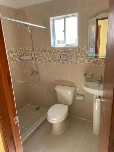 a bathroom with a toilet and a sink at Strandblick in der Residenz Apartment in Santo Domingo in La Cana