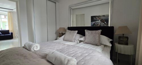 a bedroom with a large bed with white sheets and pillows at Perfect Stay - "Campari Glam Apartments" in Toruń