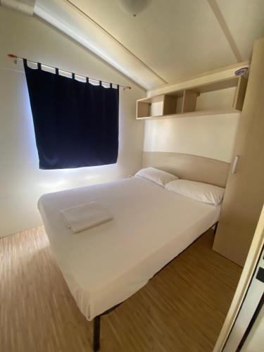Postel nebo postele na pokoji v ubytování Camping Internazionale Di Castelfusano