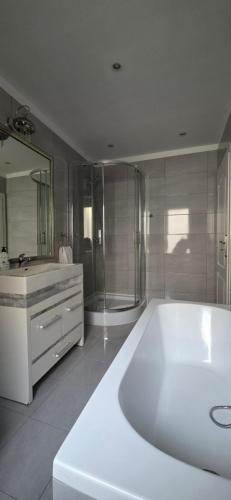 a large bathroom with a large tub and a shower at Perfect Stay - "Campari Glam Apartments" in Toruń