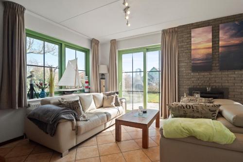 a living room with a couch and a table at Vakantiehuis Sina in Julianadorp