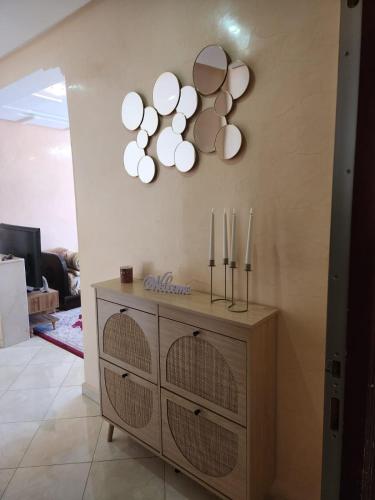 a room with a dresser with three mirrors on the wall at Dar mayssane in Agadir