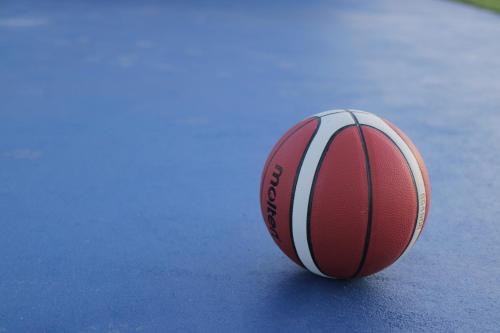 a red and white basketball sitting on a court at myrrh Resort เมอร์รีสอร์ท in Ban Nong Kop
