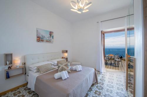 a bedroom with a bed with a view of the ocean at CASA VACANZE MARIANTONIETTA-Amalfi Coast in Praiano