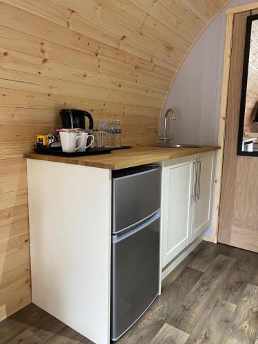 a kitchen with white cabinets and a counter top at The Inn At Charlestown in Dunfermline