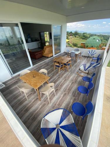 a room with tables and chairs on a balcony at Nido Acacias Cabaña romántica con jacuzzi Azulejo in Acacías
