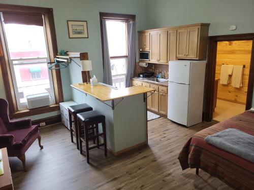 a kitchen with a refrigerator and a counter in a room at Del Norte Colorado Stone Quarry Studio Apt in Del Norte