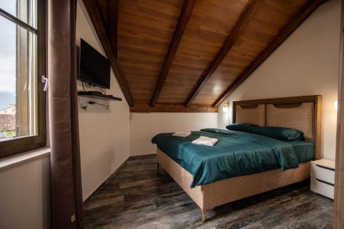 a bedroom with a bed with a television and a window at Agape Apartments in Kotor