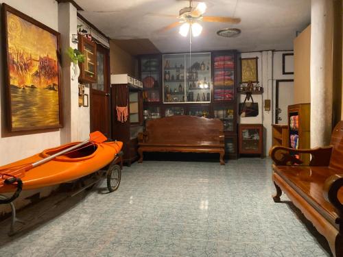a room with an orange kayak sitting on a bench at HostelBed and Art Space Phichai in Phichai