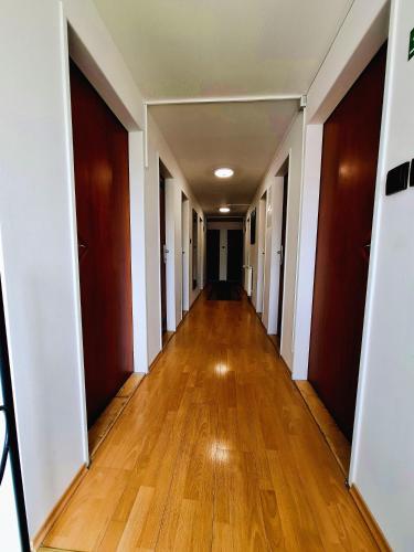 an empty hallway of an apartment with wooden floors at Penzion PANDA Tourist in Turčianske Teplice