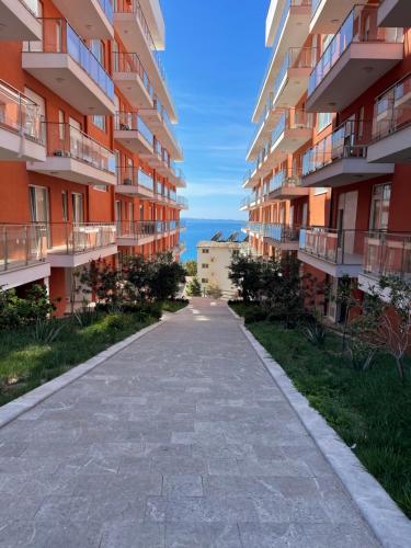 an empty sidewalk in front of some apartment buildings at S3 Apartment 4 in Margjonaj