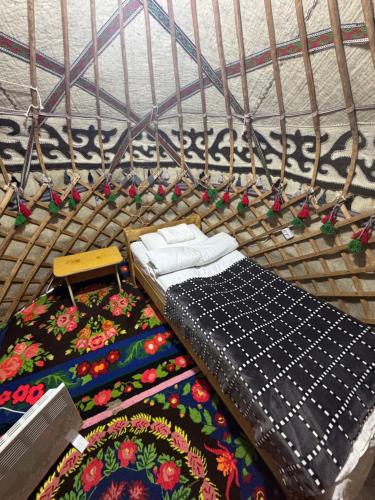 a cage with a bed and two pillows in it at Bosogo Yurt camp in Bokonbayevo