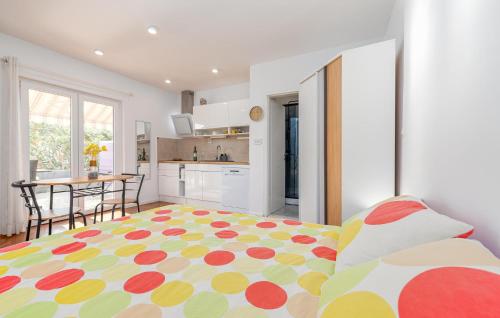 a living room with a bed and a kitchen at Stunning Apartment In Novalja With Wifi in Novalja