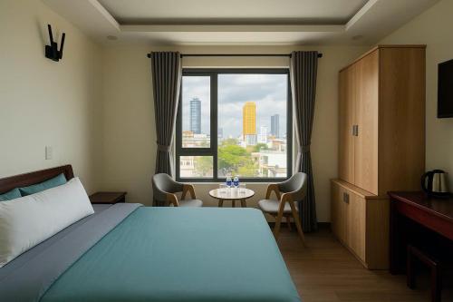 a bedroom with a bed and a large window at Stars Central Danang in Danang