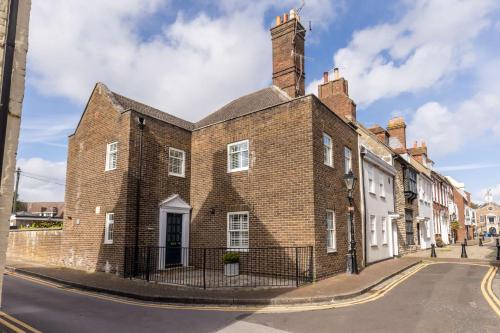an old brick building on the side of a street at Chimneys - Old Town Poole Location, with Garden and Garage in Poole