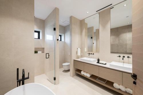 a bathroom with two sinks and a mirror at Apes Hill Barbados Golf and Resort Community in Saint James