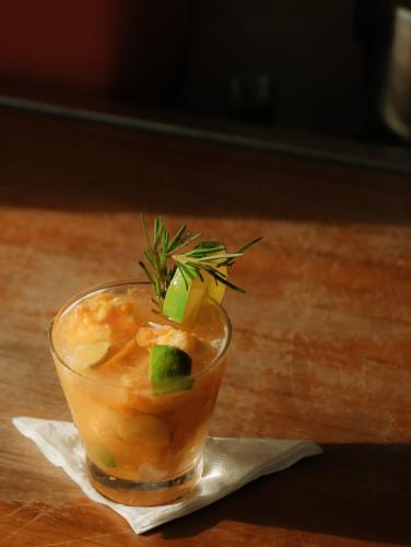 a drink sitting on a napkin with a garnishment at Villa Praia - La Villa Group in Jericoacoara