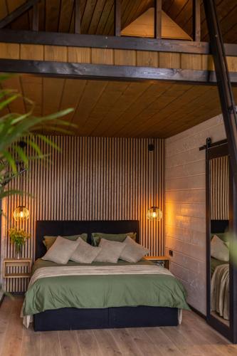 a bedroom with a large bed in a wooden wall at Tindioru Tower Resort in Nogo