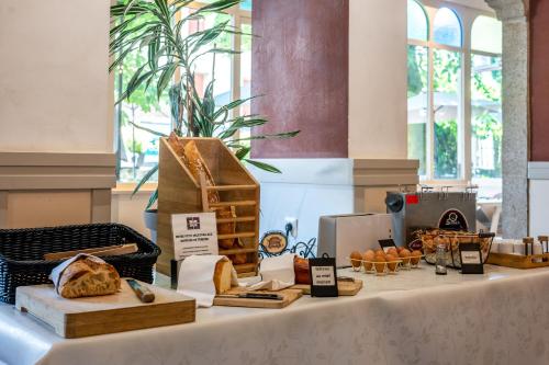 a table with bread and other items on it at Logis Le Relais de Fusies in Lacaune