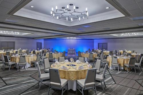 a banquet hall with tables and chairs and a chandelier at Sheraton Tucson Hotel & Suites in Tucson