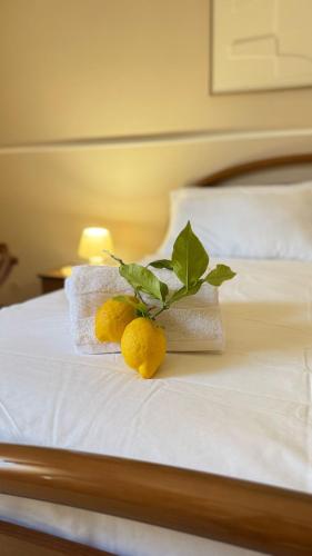 a bed with towels and lemons on it at Casa del Salento Il Limone in Trepuzzi