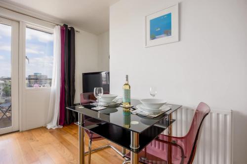 a dining room with a table and chairs and a window at Azure Views - Central Town Location, Minutes from Poole Quay in Poole