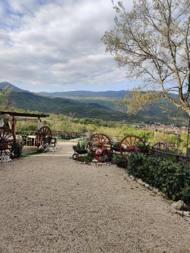 a park with benches and a view of the mountains at B&B LE GRETTE in Gioia dei Marsi