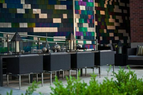 a group of tables and chairs in front of a wall at Renaissance Arlington Capital View Hotel in Arlington