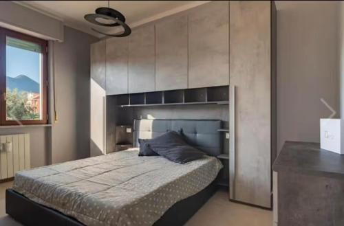 a bedroom with a large bed and a window at Loano Centro - A pochi passi dal Mare e dalla Stazione in Loano