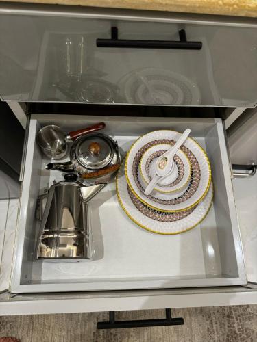 a drawer with a plate and utensils in a kitchen at شقة فندقية من غرفة و صالة مع بالكونة مطلة in Jeddah