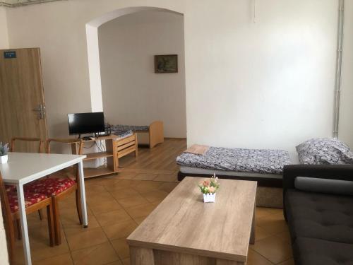 a living room with a couch and a table at Apartmány Pražská in Ústí nad Labem