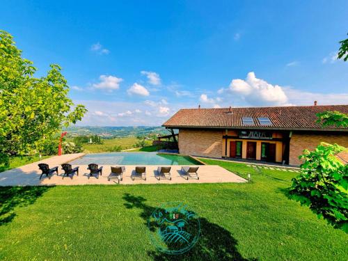 a house with a yard with chairs and a pool at Ca 'nsel Bric in Canelli