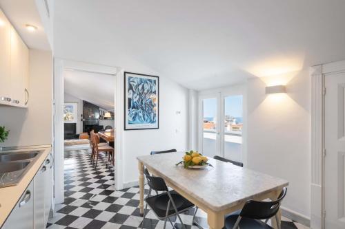a kitchen and dining room with a table and chairs at AMORE RENTALS - The Roof in Sorrento