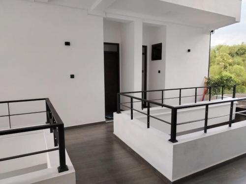 a white room with two bunk beds in it at Diora Hotel in Ratnapura