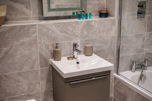 a bathroom with a sink and a shower at Little Sea - Moments from Waterfront Restaurants in Poole