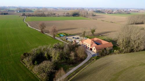 an aerial view of a house in the middle of a field at Gîte à la ferme 4 à 6 personnes. in Vieille-Chapelle