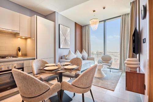 a kitchen and living room with a table and chairs at STAY BY LATINEM Luxury 1BR Holiday Home W 2709 Near Burj Khalifa in Dubai