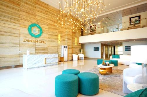 a lobby with blue stools in a hotel room at Soundproof 2 Bed apartment in Lahore Zameen Opal in Lahore
