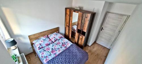 a bedroom with a bed and a mirror at Apartament "Cztery Pory Roku" in Świdnik