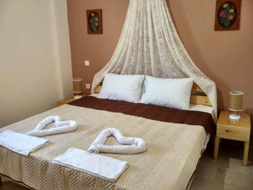 a bedroom with a bed with towels on it at Villa Ocean with panoramic view in Stómion