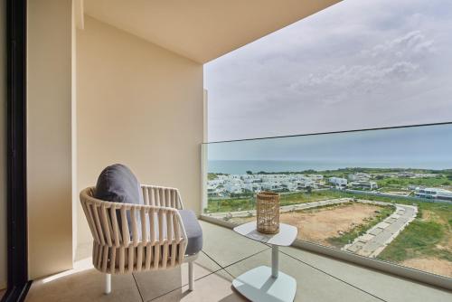 a room with a chair and a large window at The Editory by the Sea Lagos in Lagos