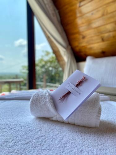a hotel room with towels on a bed at Rancho Navarro - Cabana A-Frame in Pôrto de Pedras