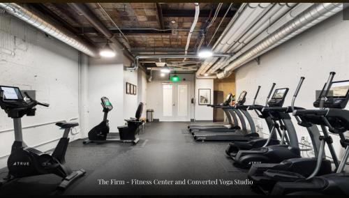 a gym with a row of treadms and cardio machines at Historic Charm meet Modern Amenities in Tacoma