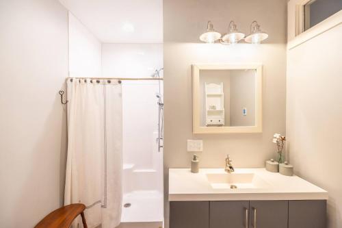 a bathroom with a sink and a shower at Dreamy Artist Chalet in Secluded Historic Village in Warren