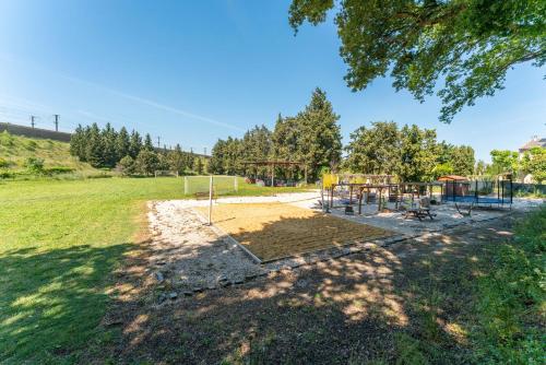 a playground in a field with a park at Gite en Campagne Léonie in Avignon