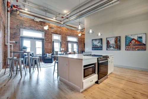 an open kitchen and dining room with a brick wall at The Majestic Lofts in Nashville