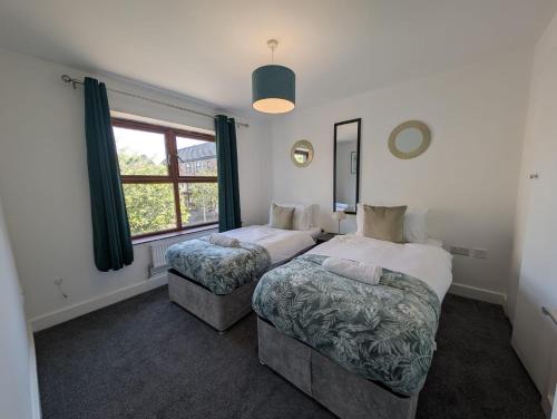 a bedroom with two beds and a window at Spacious Large 4 Bed Contractor in Dallington