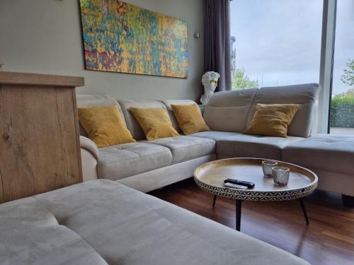 a living room with a couch and a table at "myHarbourfront", luxuriöses Wohnen an der Hafenmole in Rostock