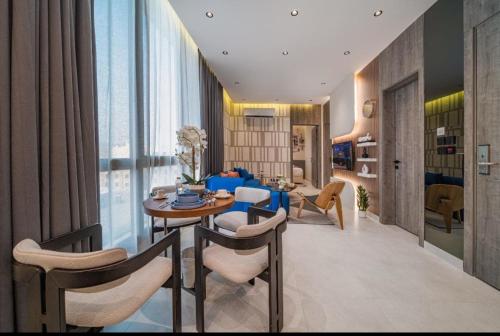 a living room with a table and chairs in a room at SADEN Al-Salama in Jeddah